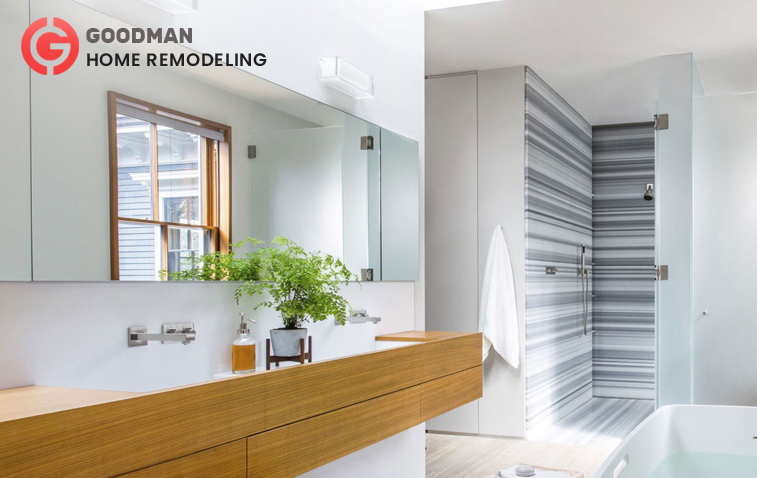 Contemporary bathroom with wooden floating vanity and long mirror.